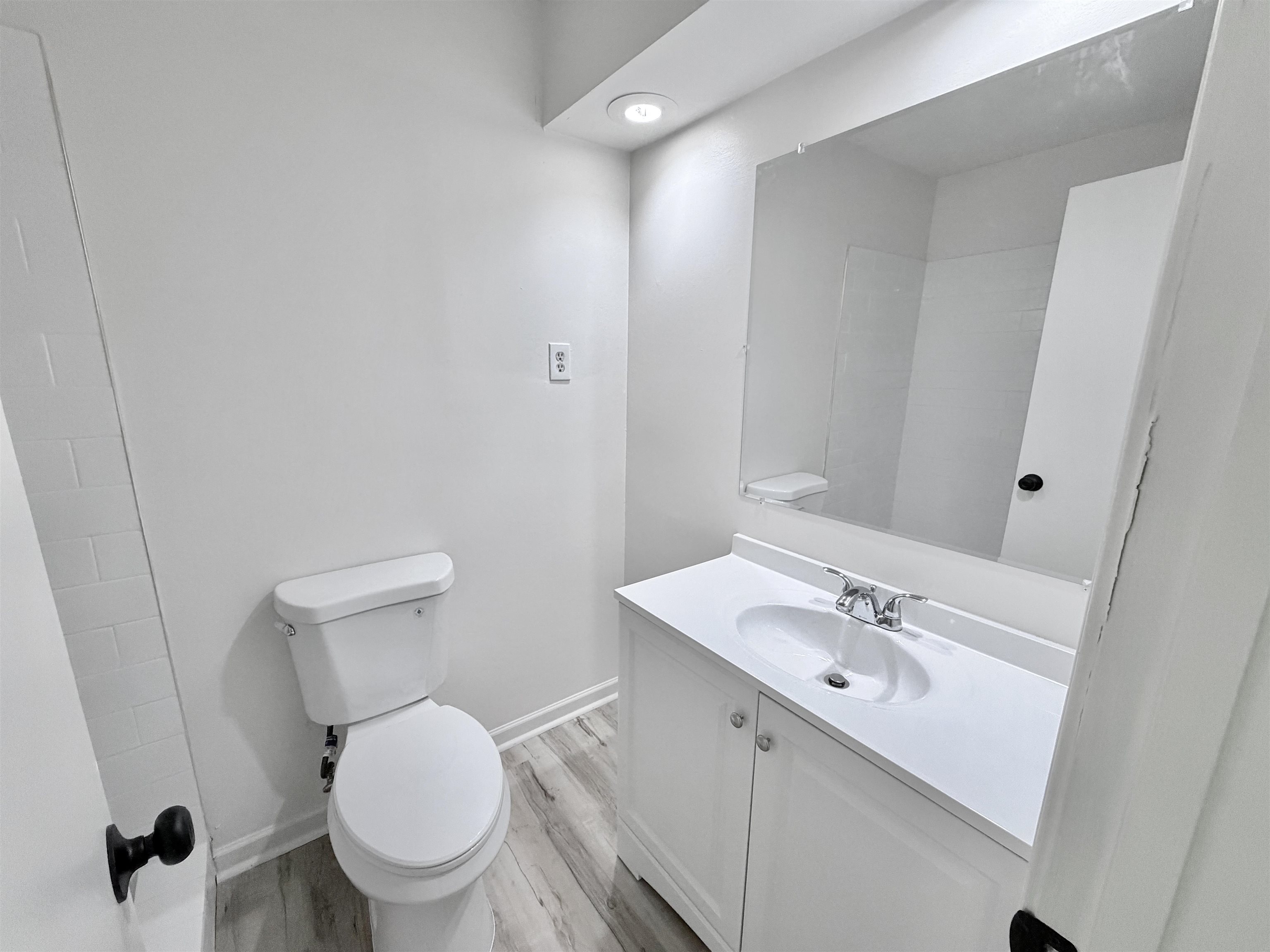 4278 Auburn Road Memphis, TN 38116 - Photo 15 of 28 Bathroom featuring a white vanity with an integrated sink, polished chrome faucet, and a large wall-mounted mirror