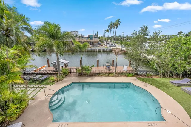a front view of a house with swimming pool having outdoor seating