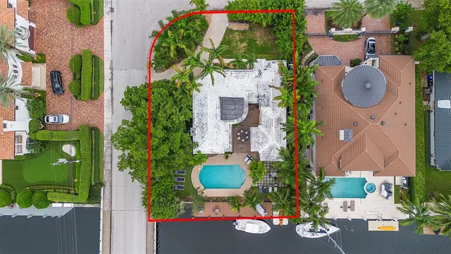 an aerial view of a house with yard swimming pool and outdoor seating