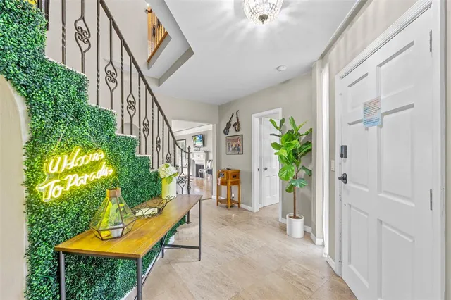 a view of an entryway with wooden floor and a garden