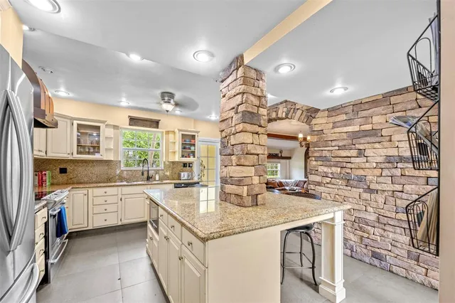 a kitchen with stainless steel appliances granite countertop a sink and cabinets