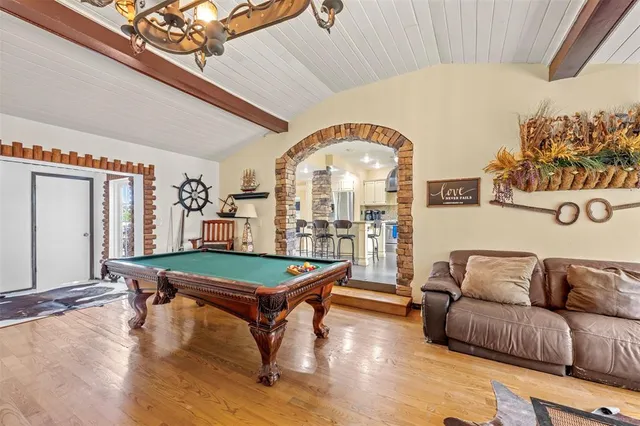 a living room with furniture a table and a large window