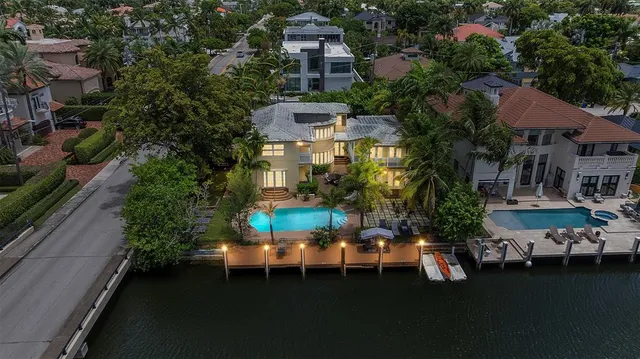 an aerial view of a house with a yard basket ball court and outdoor seating