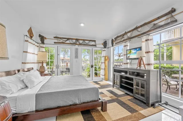 a living room with furniture a large window and a rug