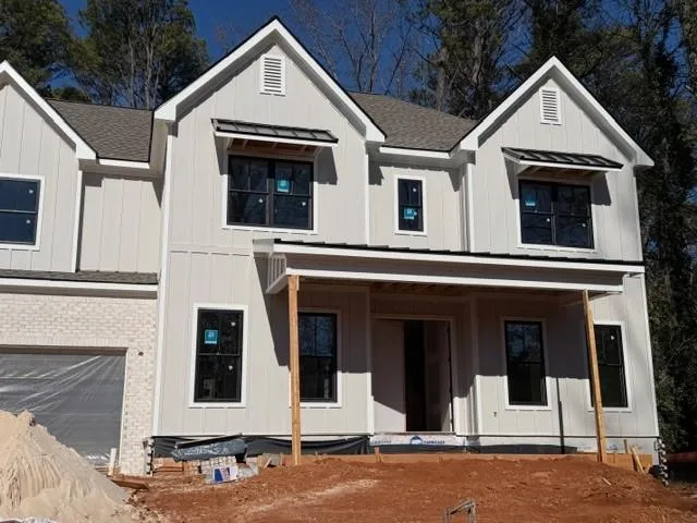 a view of a white house with large windows