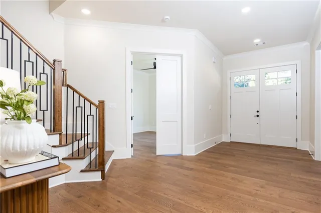 a dining room with furniture a chandelier and wooden floor