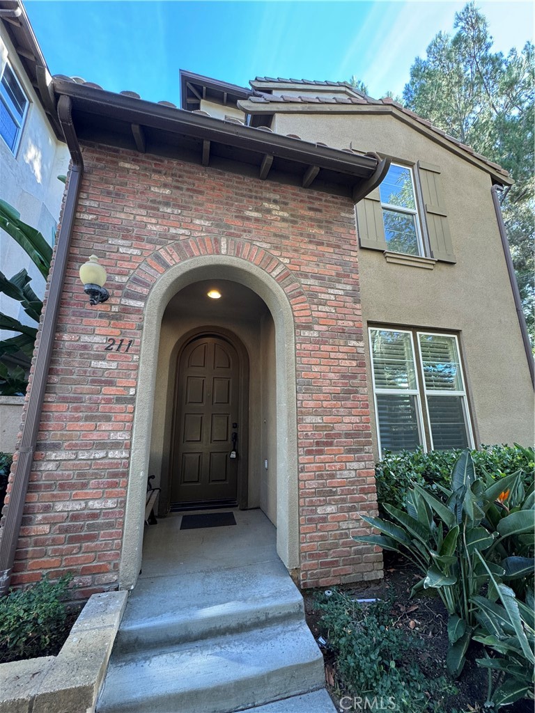 211 Tall Oak Irvine, CA 92603 - Photo 1 of 12 a front view of a house with entrance