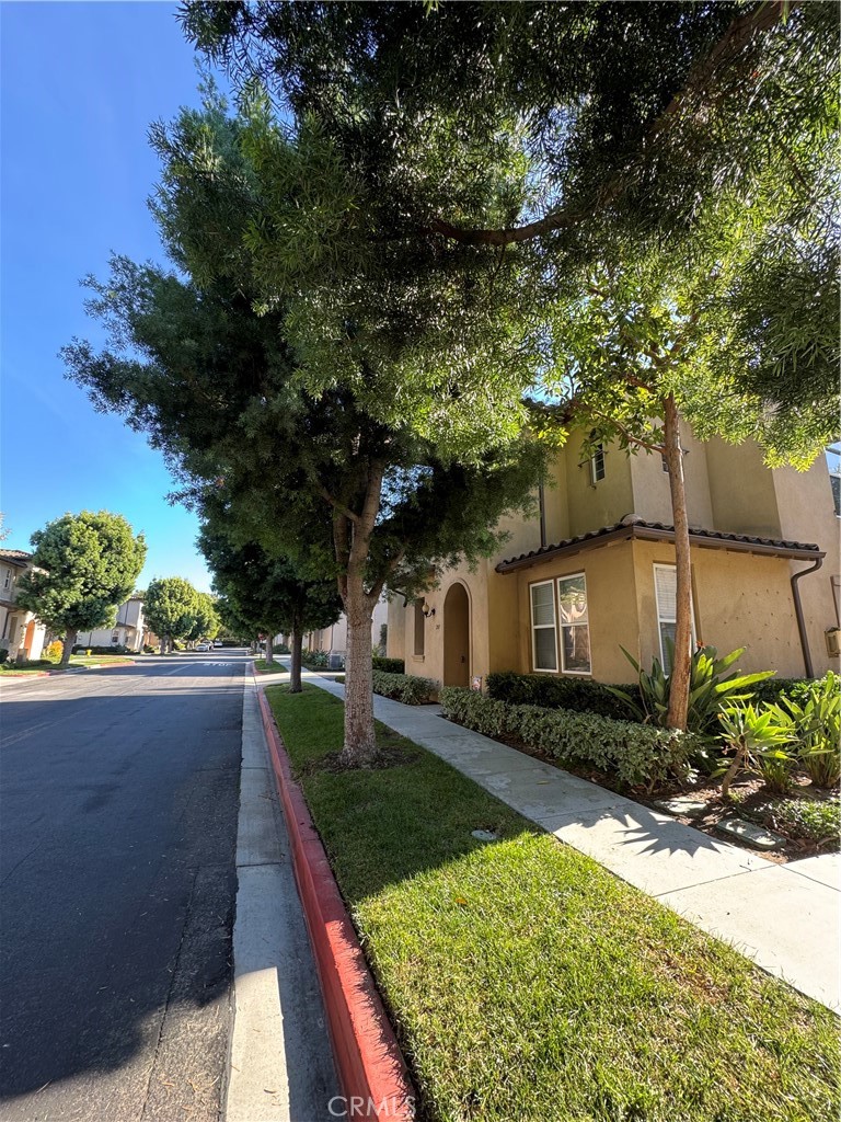 211 Tall Oak Irvine, CA 92603 - Photo 2 of 12 a front view of a house with garden