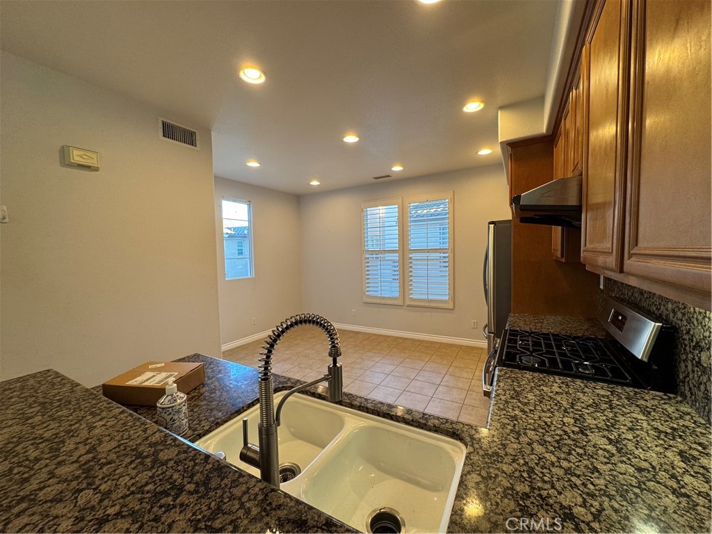 211 Tall Oak Irvine, CA 92603 - Photo 6 of 12 a kitchen with a sink and a stove top oven