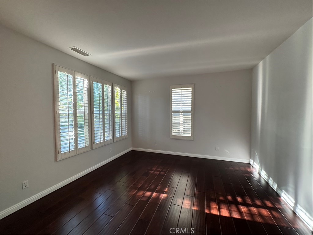 211 Tall Oak Irvine, CA 92603 - Photo 10 of 12 a view of an empty room with wooden floor and a window