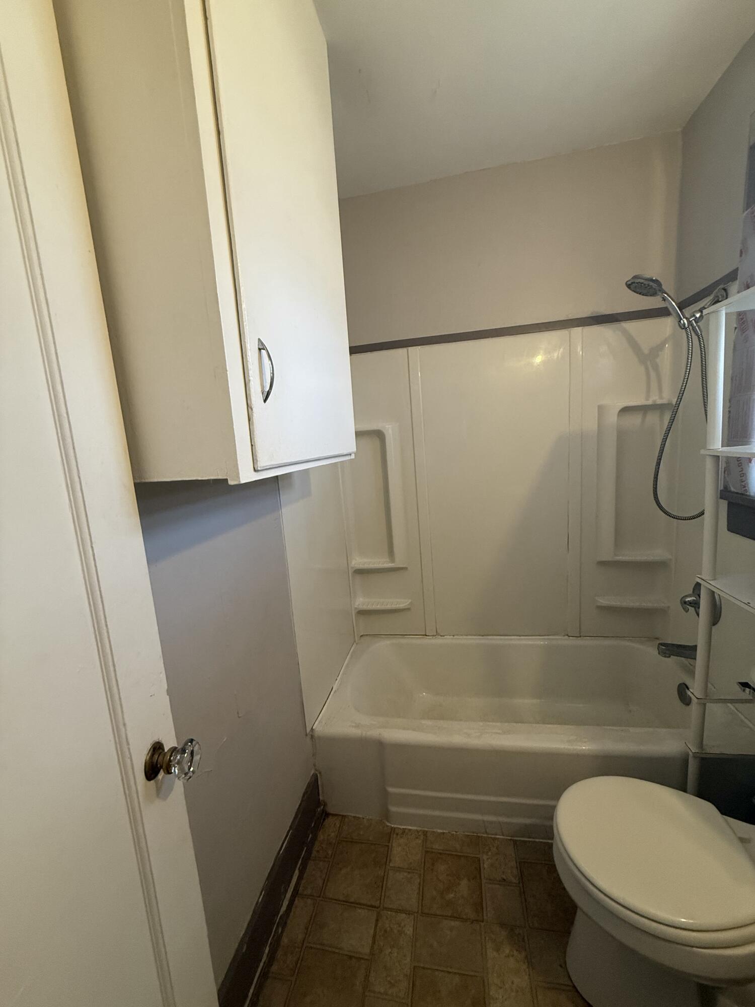 2320 21st Street Lubbock, TX 79411 - Photo 27 of 29 a bathroom with a toilet and a shower