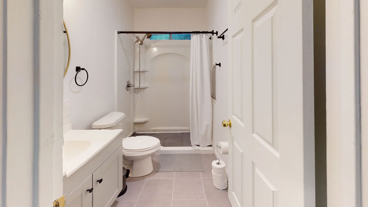 1109 Gardner Cove Austin, TX 78721 - Photo 8 of 13 Functional full bathroom featuring a convenient walk-in shower and ample vanity space.