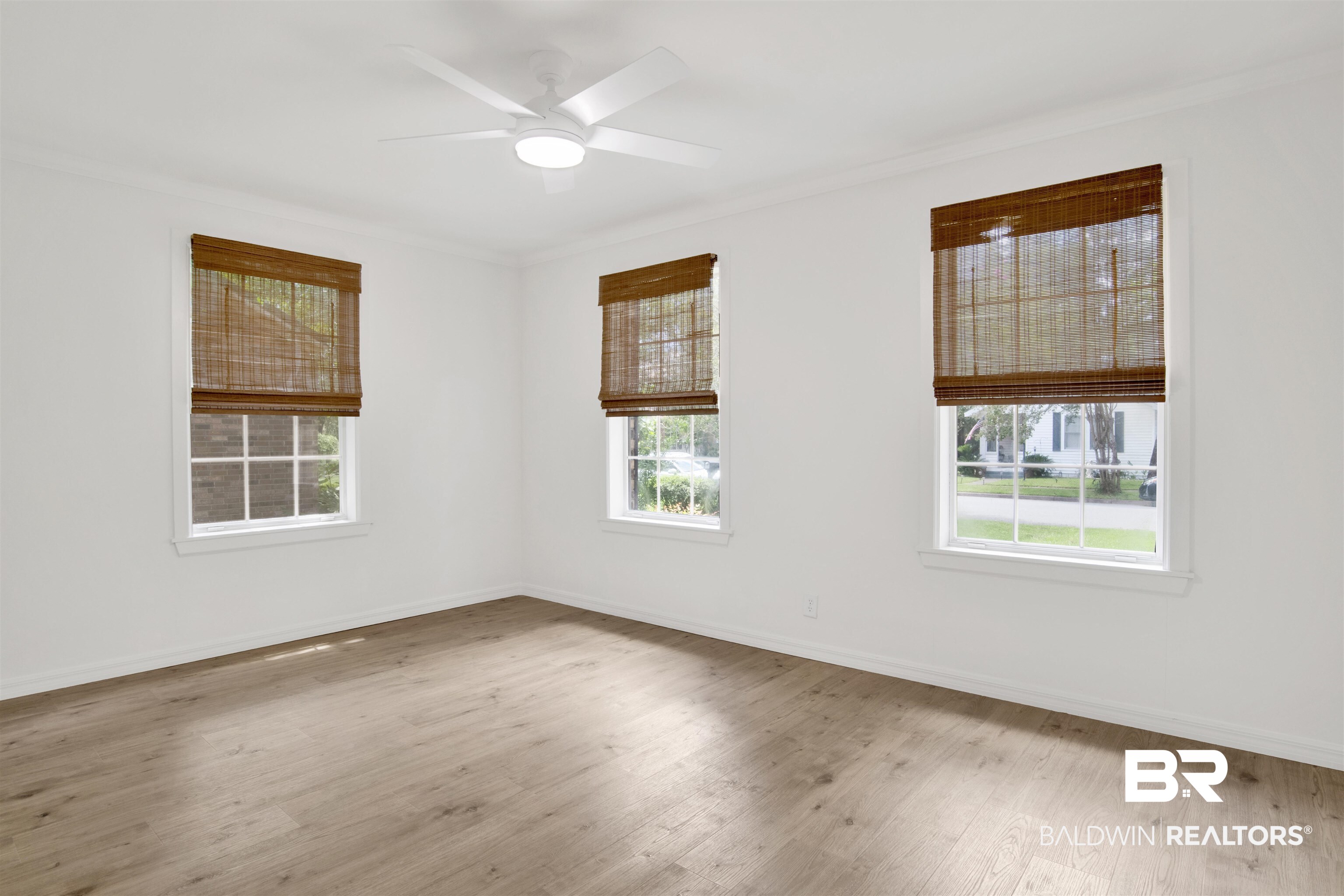317 Lee Street Chickasaw, AL 36611 - Photo 19 of 40 Bedroom 2 room with two closets, crown molding, wood finished floors, and ceiling fan