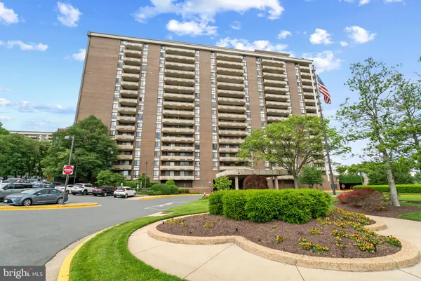 a front view of a multi story building with yard