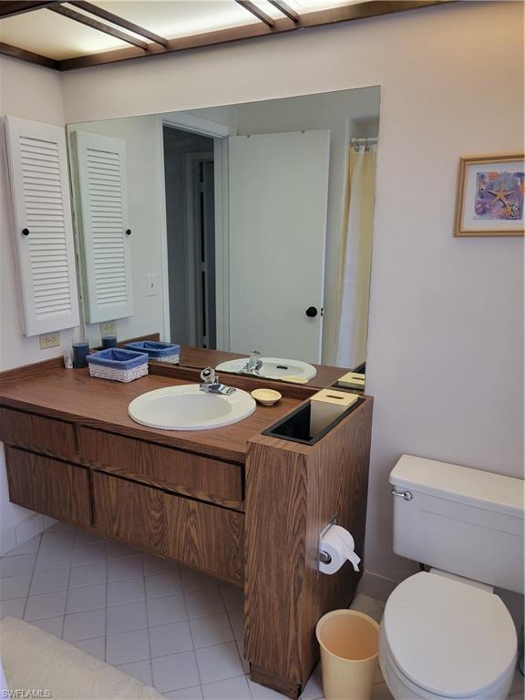 735 High Pines Drive Naples, FL 34103 - Photo 14 of 30 Bathroom with vanity, tile patterned floors, and toilet