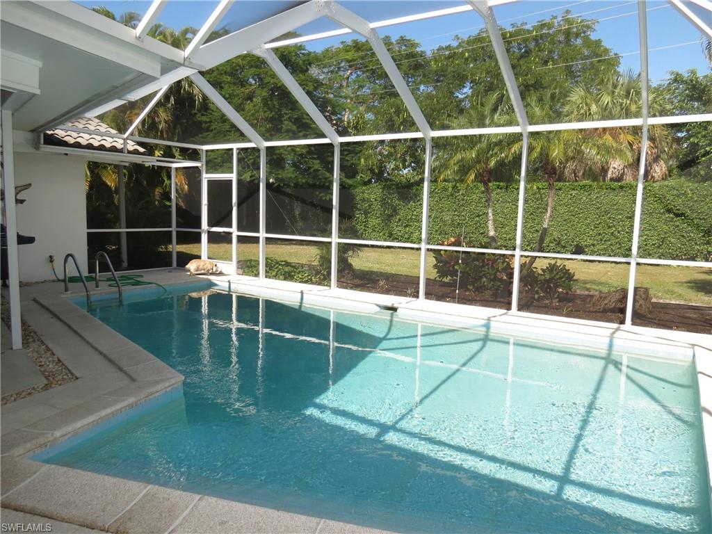 735 High Pines Drive Naples, FL 34103 - Photo 3 of 30 View of swimming pool featuring glass enclosure and a patio