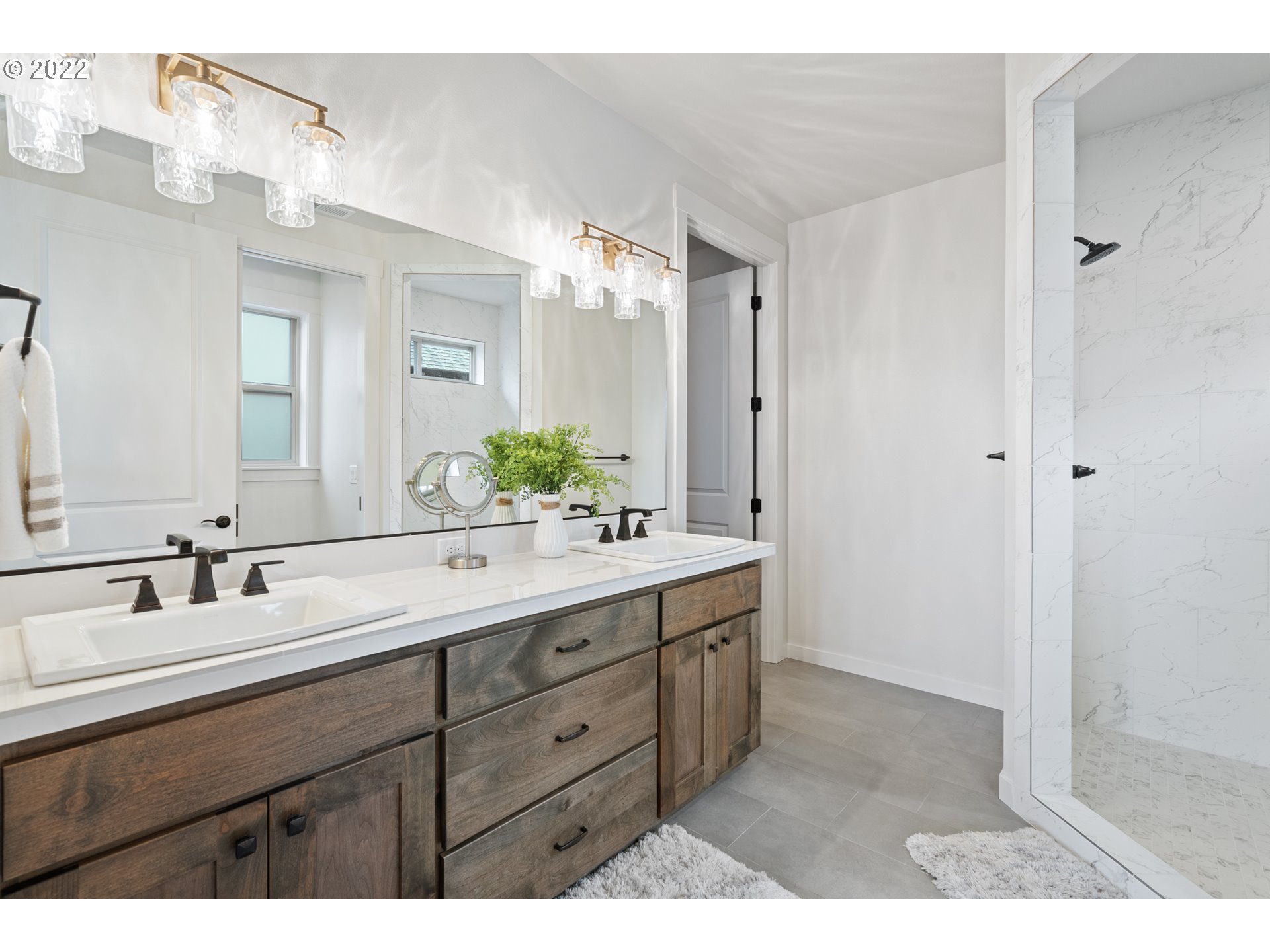 818 South 88th Avenue Ridgefield, WA 98642 - Photo 22 of 32 a bathroom with a sink double vanity granite tub shower and a mirror