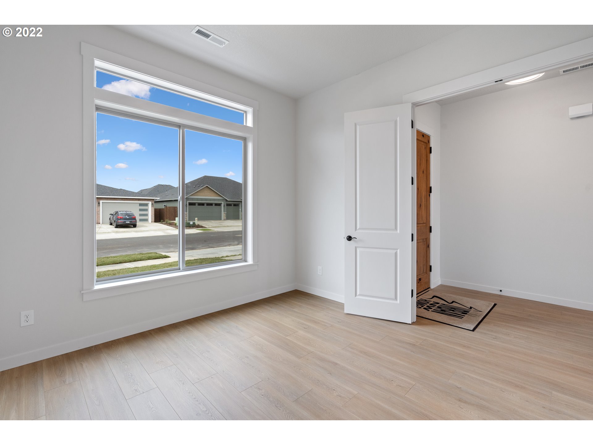 818 South 88th Avenue Ridgefield, WA 98642 - Photo 3 of 32 a view of an empty room with a window and wooden floor