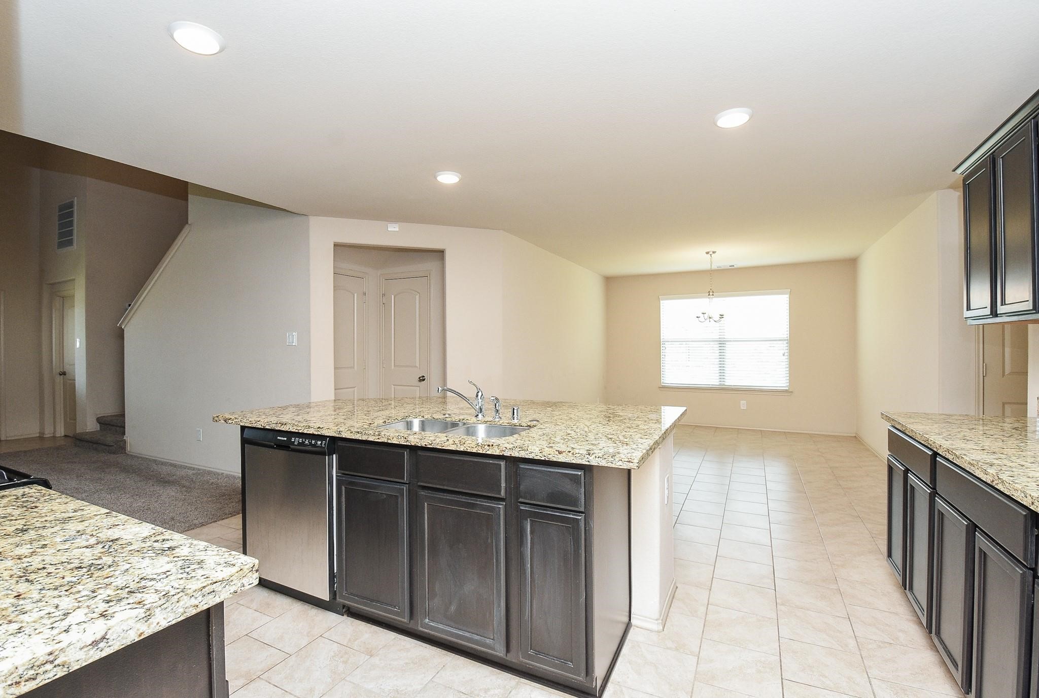 23306 Joyful Way Spring, TX 77373 - Photo 13 of 32 a kitchen with granite countertop a sink and a stove