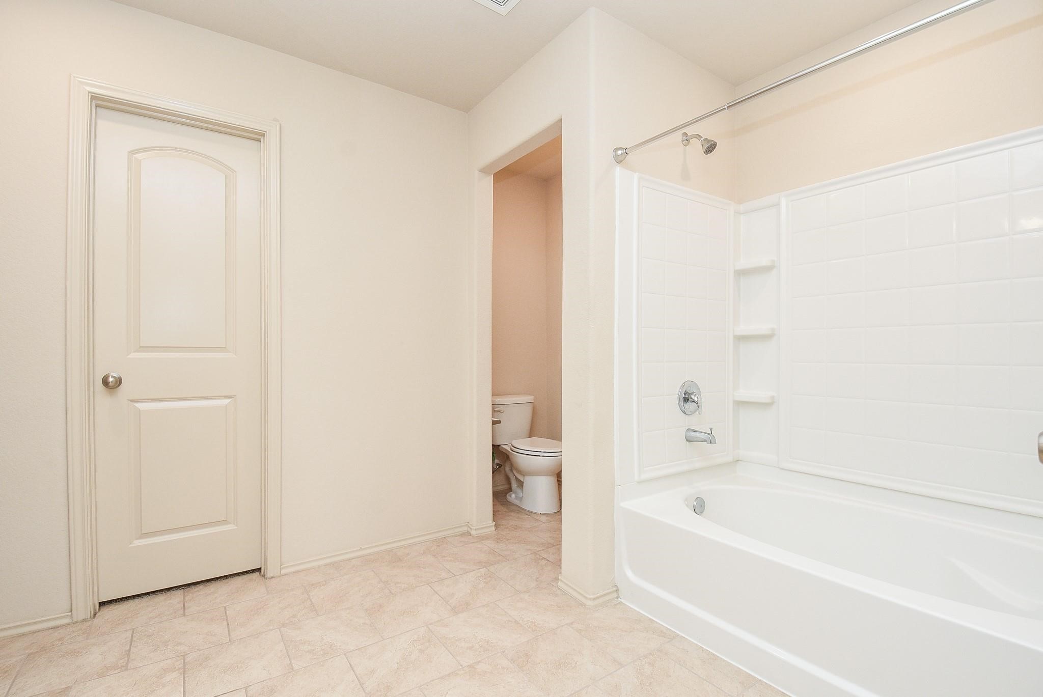 23306 Joyful Way Spring, TX 77373 - Photo 17 of 32 a bathroom with a bathtub and a shower
