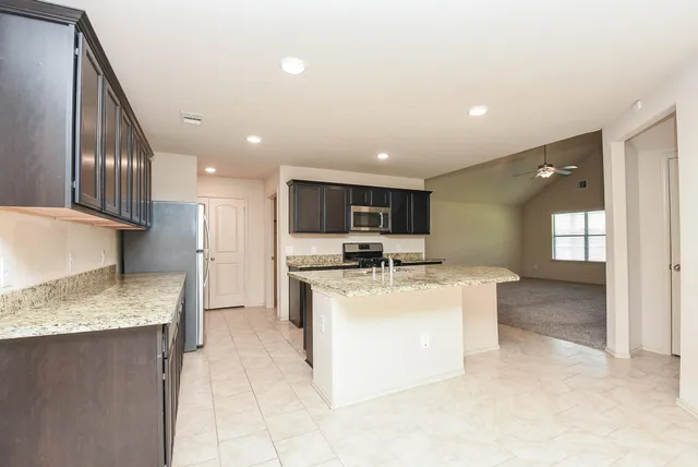 a view of kitchen with sink microwave and refrigerator