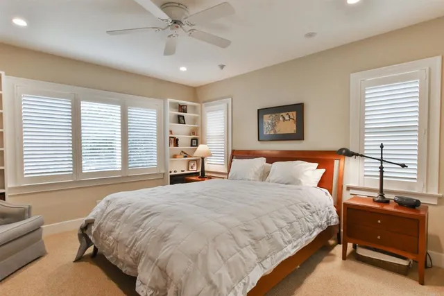 a spacious bedroom with a bed and a couch