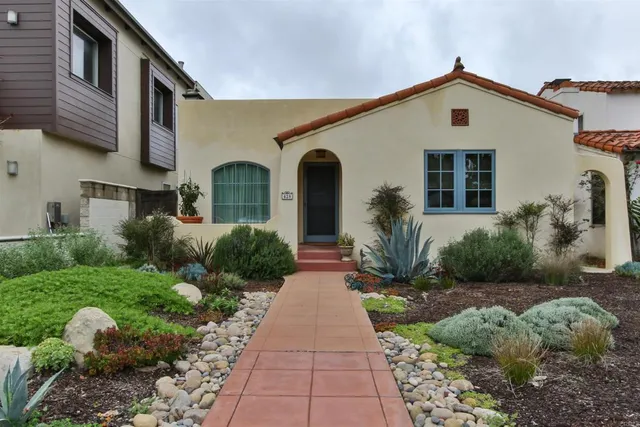 a front view of a house with garden