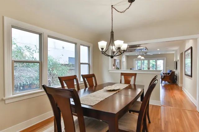 a view of a dining room with furniture wooden floor and chandelier