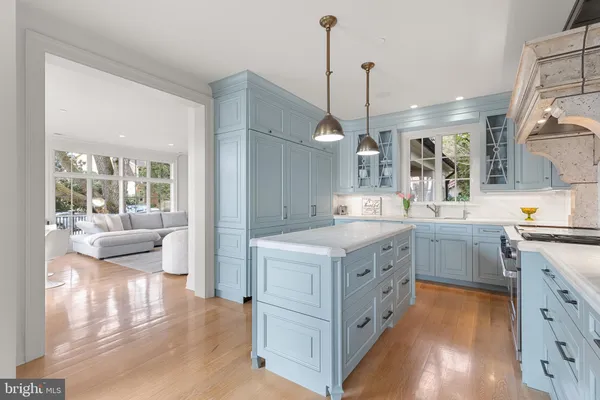 a kitchen with a stove and a wooden floor