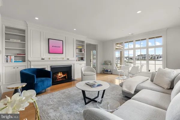 a living room with furniture fireplace and a large window
