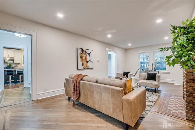 a dining room with furniture a chandelier and wooden floor