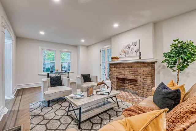 a dining room with furniture a chandelier and wooden floor