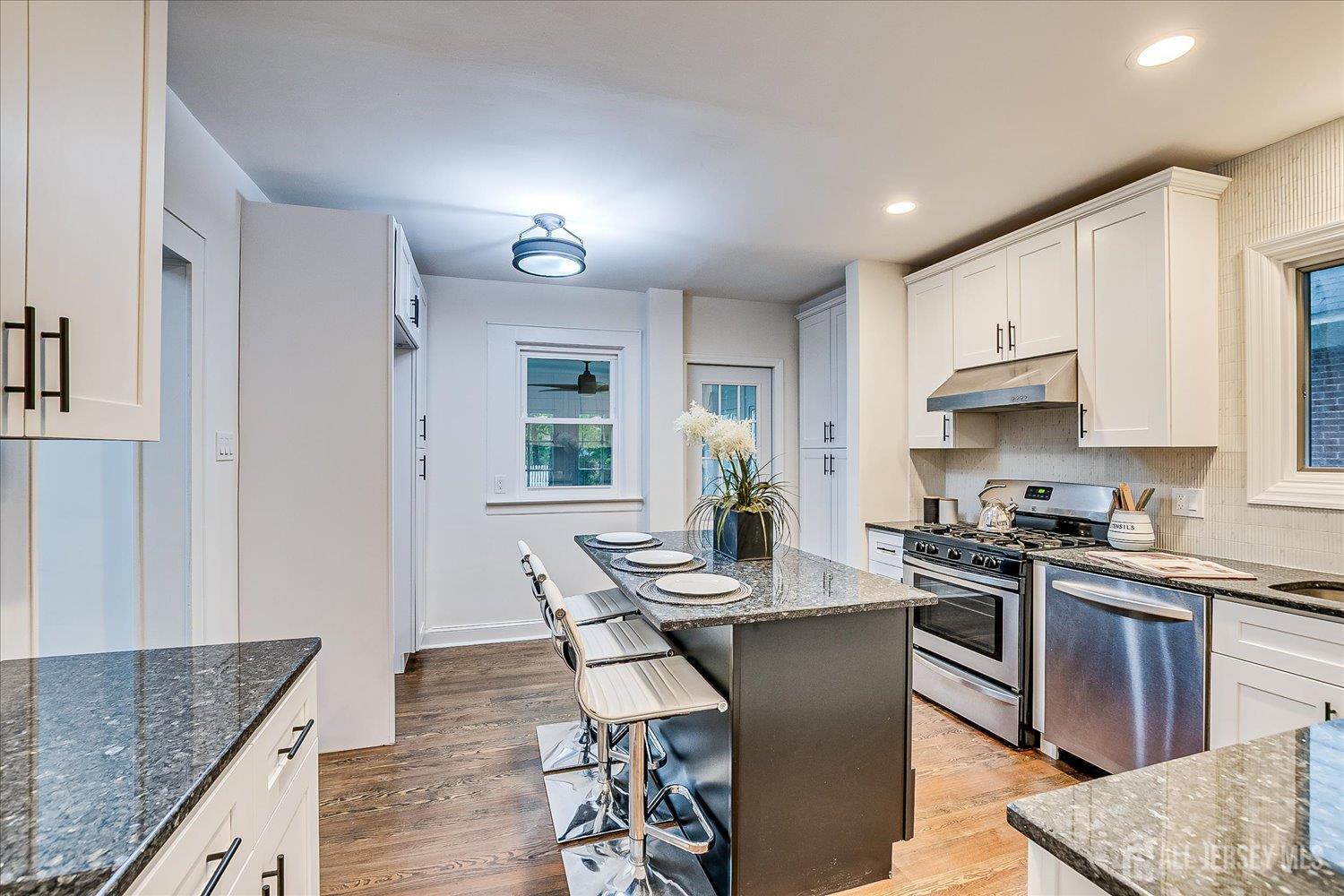 140 Oakview Avenue Maplewood, NJ 07040 - Photo 28 of 67 a kitchen with granite countertop kitchen island wooden cabinets and stainless steel appliances