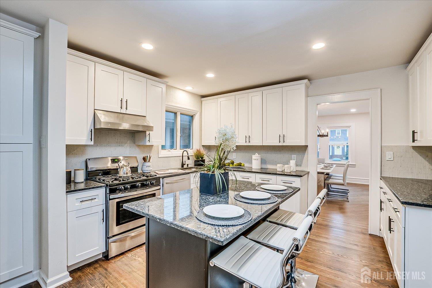 140 Oakview Avenue Maplewood, NJ 07040 - Photo 31 of 67 a kitchen with stainless steel appliances kitchen island granite countertop a stove a sink and a refrigerator