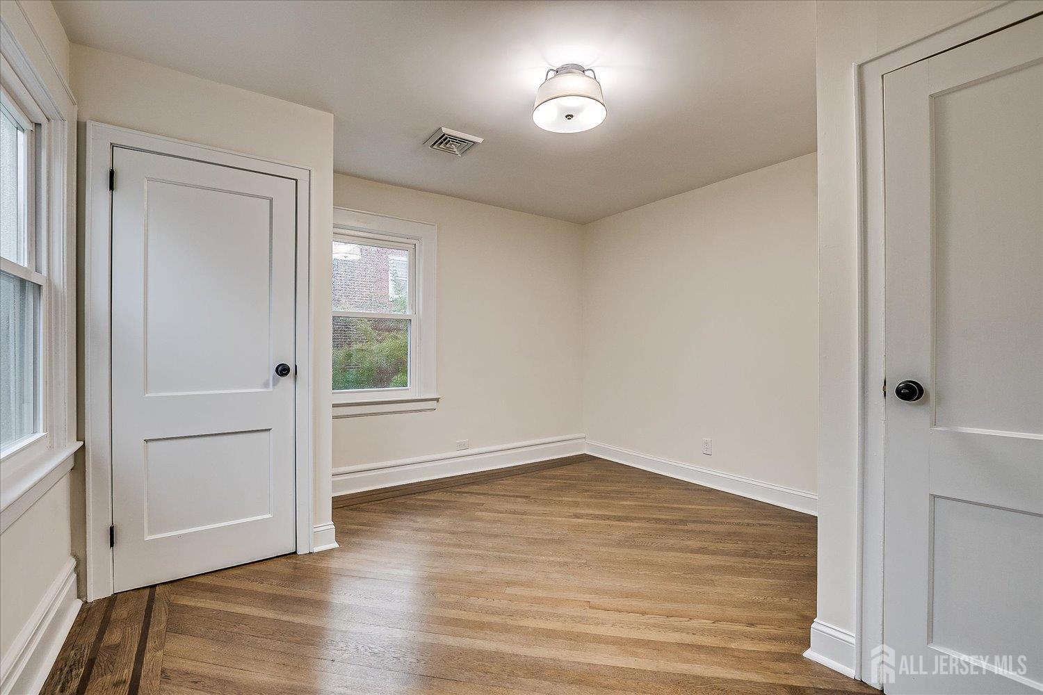140 Oakview Avenue Maplewood, NJ 07040 - Photo 46 of 67 an empty room with wooden floor and windows