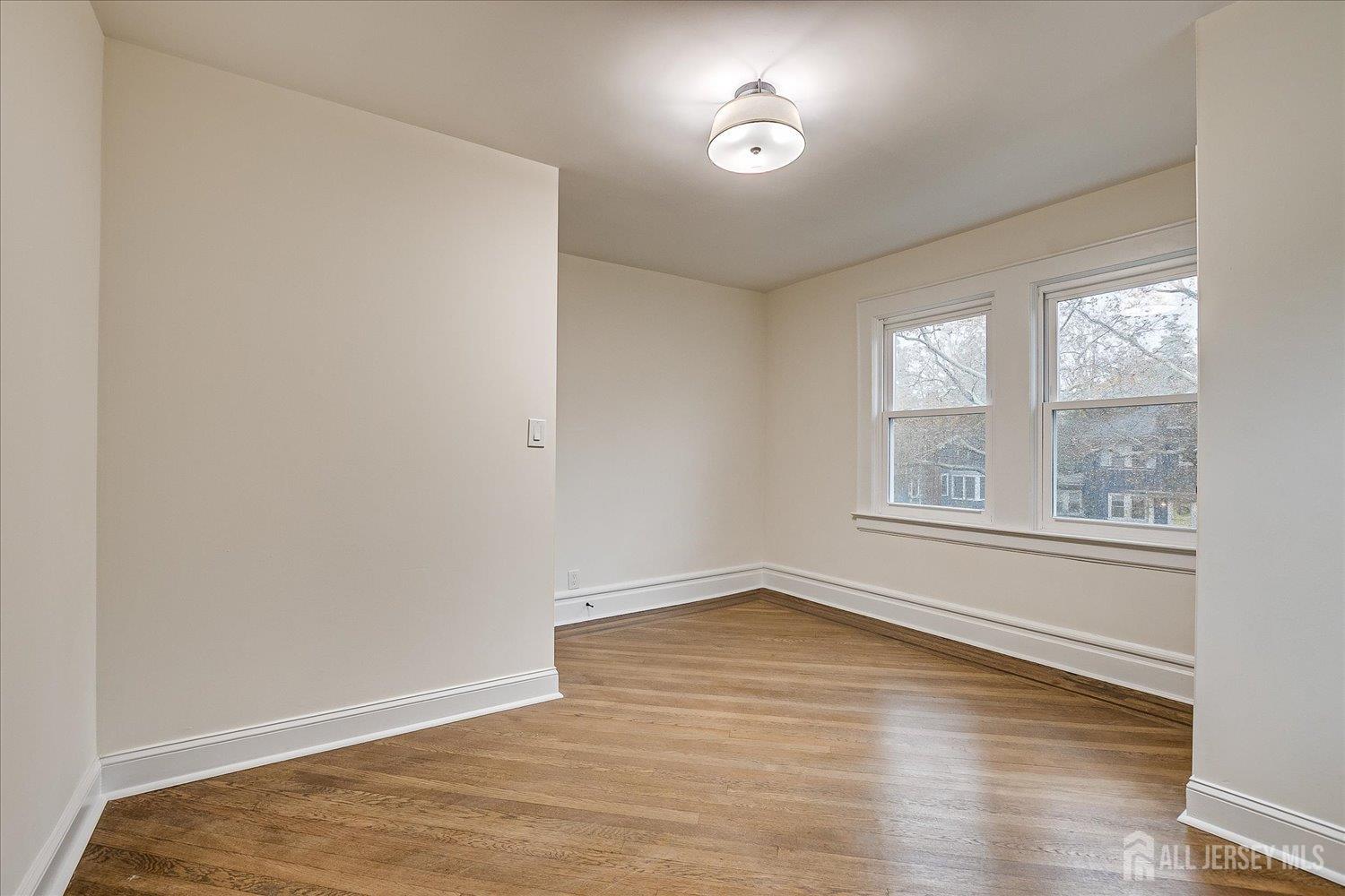 140 Oakview Avenue Maplewood, NJ 07040 - Photo 47 of 67 an empty room with wooden floor and windows