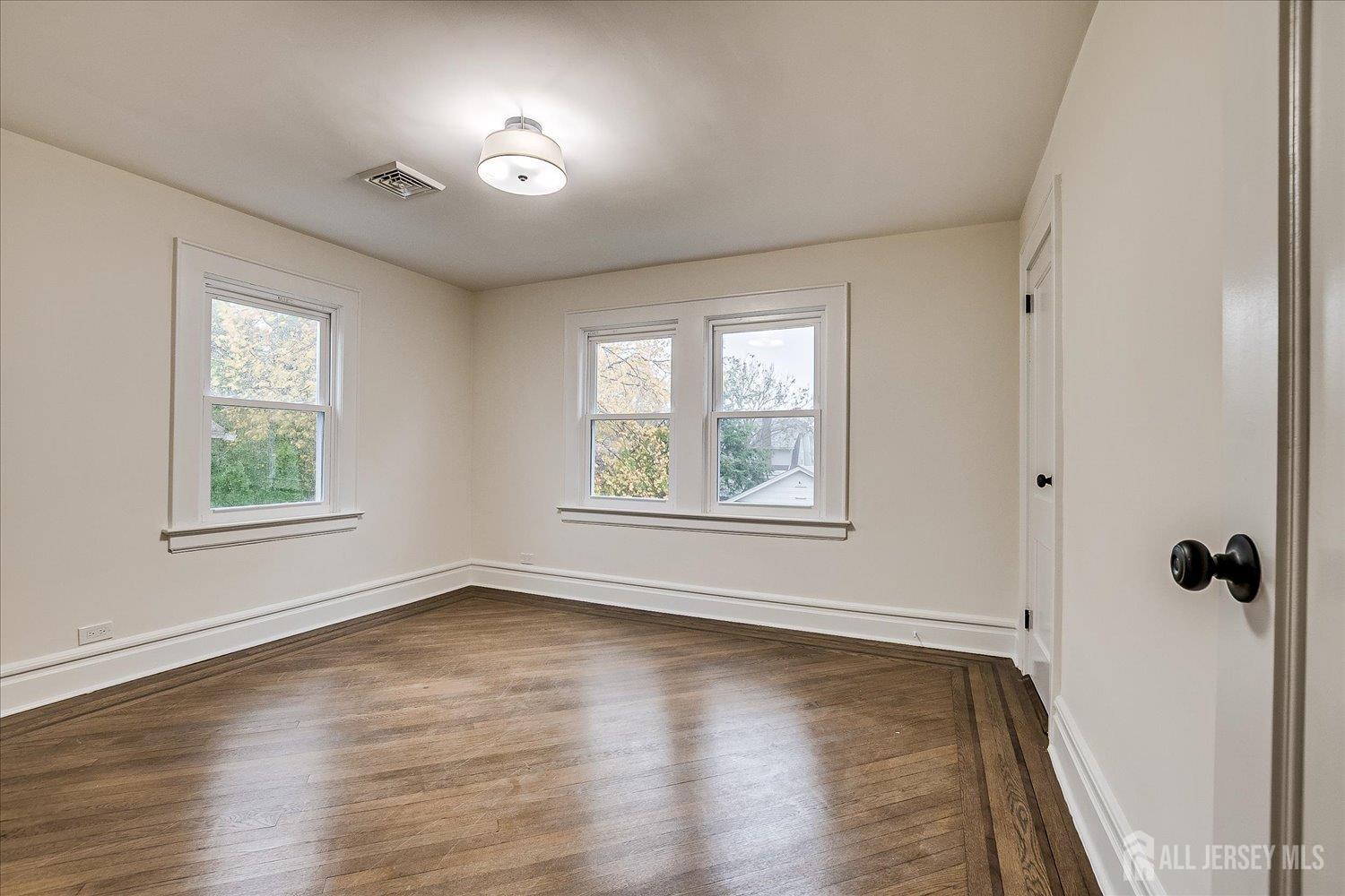 140 Oakview Avenue Maplewood, NJ 07040 - Photo 48 of 67 an empty room with wooden floor and windows