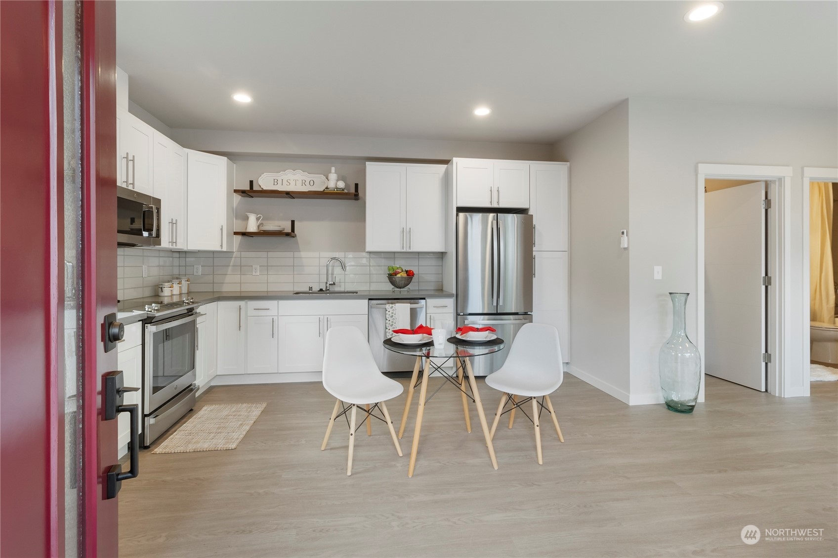 8410 17th Avenue Southwest, Unit B Seattle, WA 98106 - Photo 2 of 18 a kitchen with white cabinets and stainless steel appliances