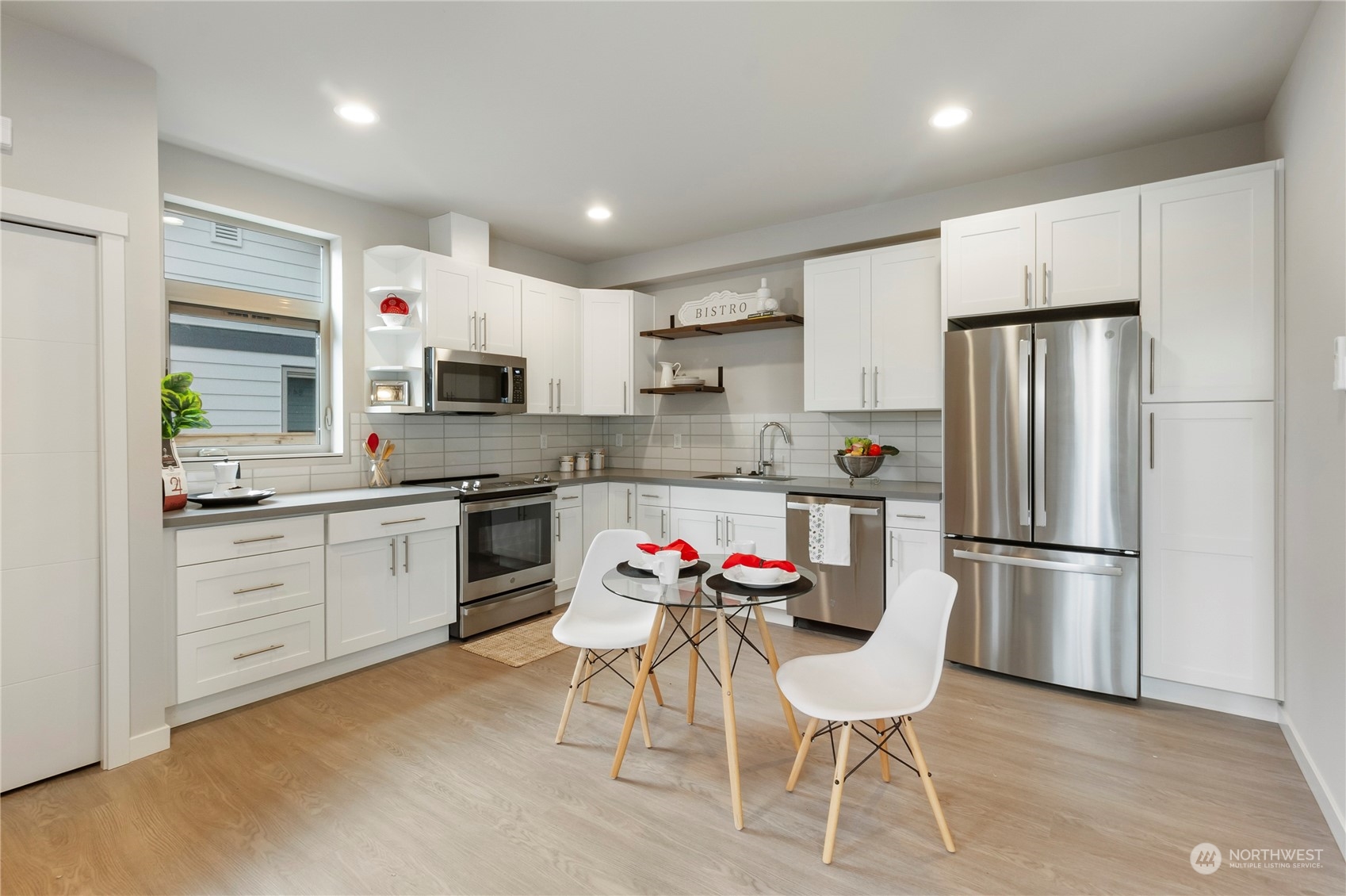 8410 17th Avenue Southwest, Unit B Seattle, WA 98106 - Photo 5 of 18 a kitchen with white cabinets and stainless steel appliances