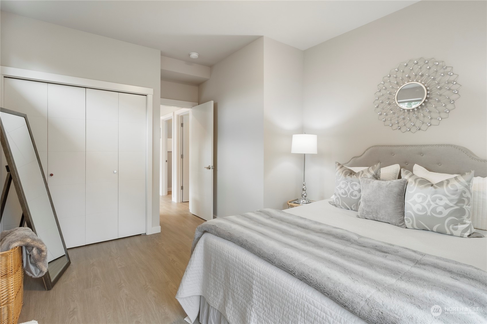 8410 17th Avenue Southwest, Unit B Seattle, WA 98106 - Photo 9 of 18 a bedroom with a bed and a mirror