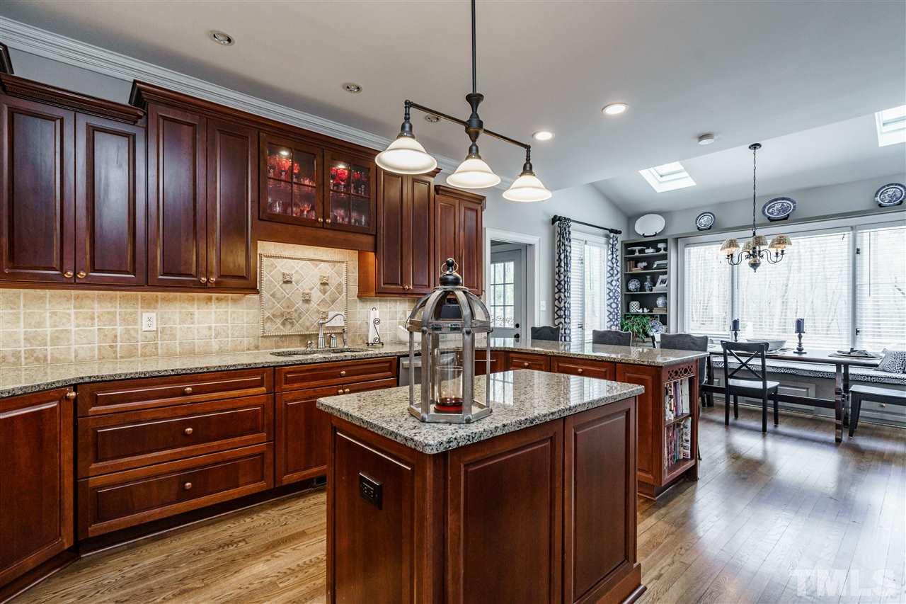 10709 Dunhill Terrace Raleigh, NC 27615 - Photo 11 of 30 Warm and inviting kitchen calls out for meals around the table. The breakfast area is light filled overlooking the most beautiful sights nature has to offer.