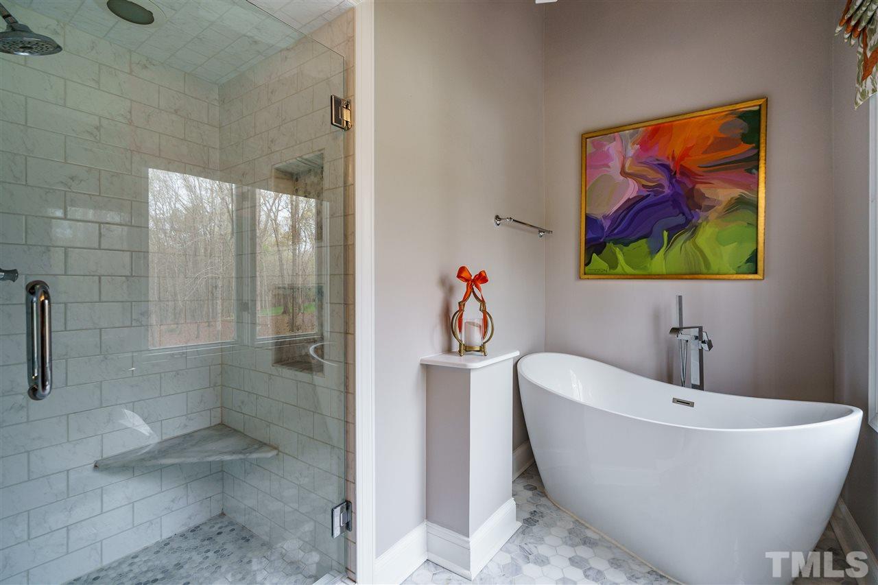10709 Dunhill Terrace Raleigh, NC 27615 - Photo 19 of 30 Free standing tub, tile floors, and huge shower make this a perfect space.