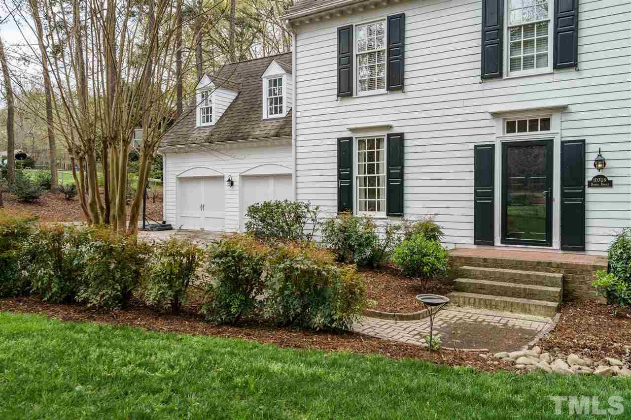 10709 Dunhill Terrace Raleigh, NC 27615 - Photo 3 of 30 Beautiful brick sidewalk leads you from the home to a wide driveway where several cars can fit comfortable outside of the 2 car garage.