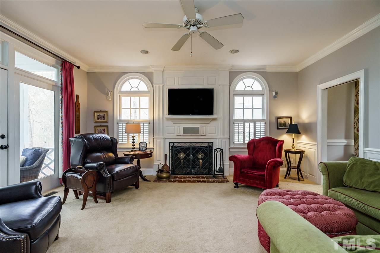 10709 Dunhill Terrace Raleigh, NC 27615 - Photo 7 of 30 Beautiful family room with a fireplace is a perfect gathering spot. Family room opens up to a gorgeous screened porch area which overlooks an immaculately landscaped backyard.