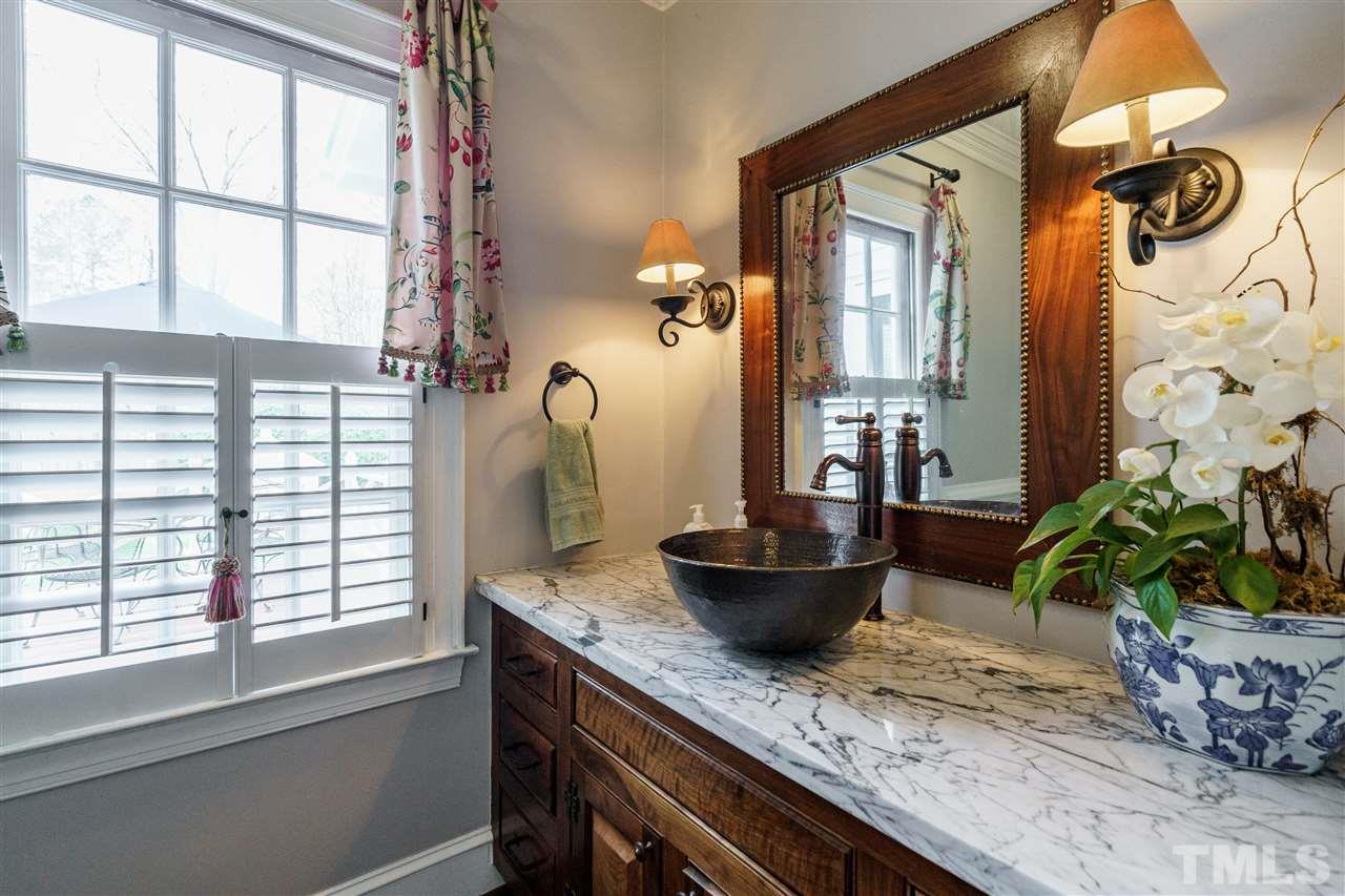 10709 Dunhill Terrace Raleigh, NC 27615 - Photo 10 of 30 The downstairs powder room is warm and welcoming with a beautiful granite counter top and exquisite bathroom vanity. No detail was left unattended in this home.