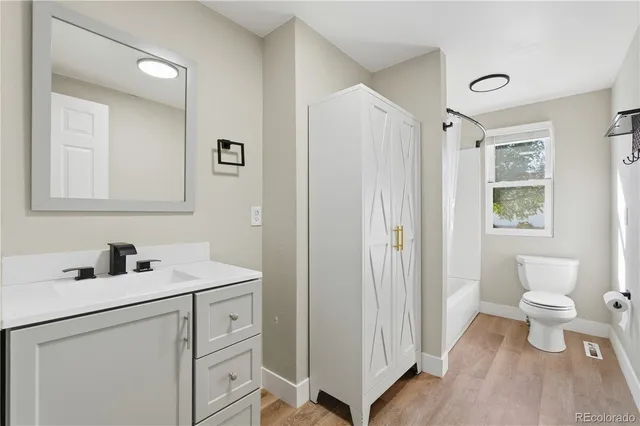 a open kitchen with stainless steel appliances granite countertop a refrigerator and a stove top oven