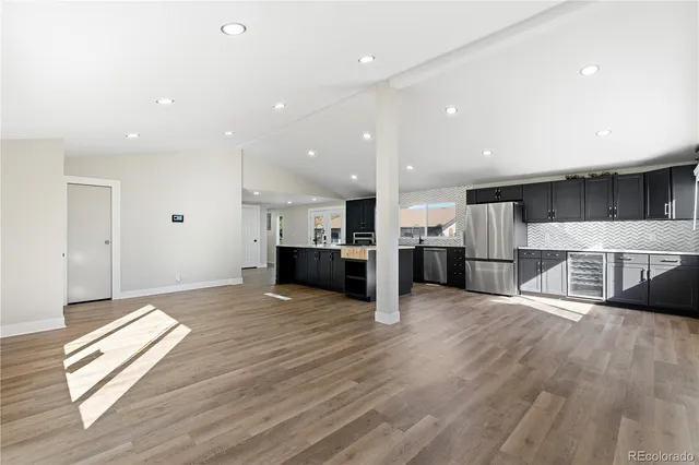 a view of kitchen with cabinets and wooden floor