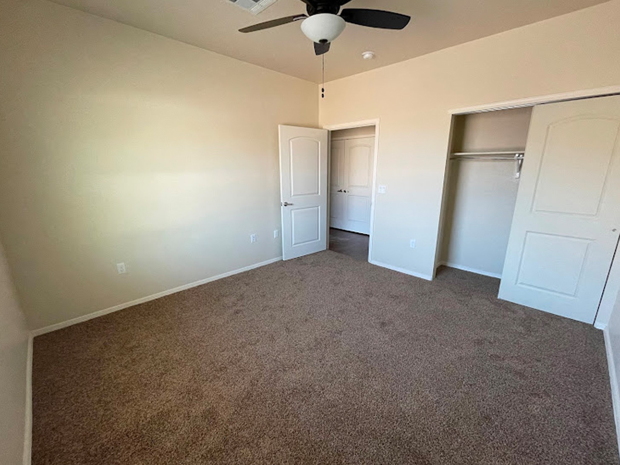 1104 Lechuguilla, Unit 49 Alpine, TX 79830 - Photo 2 of 6 a view of an empty room with a ceiling fan