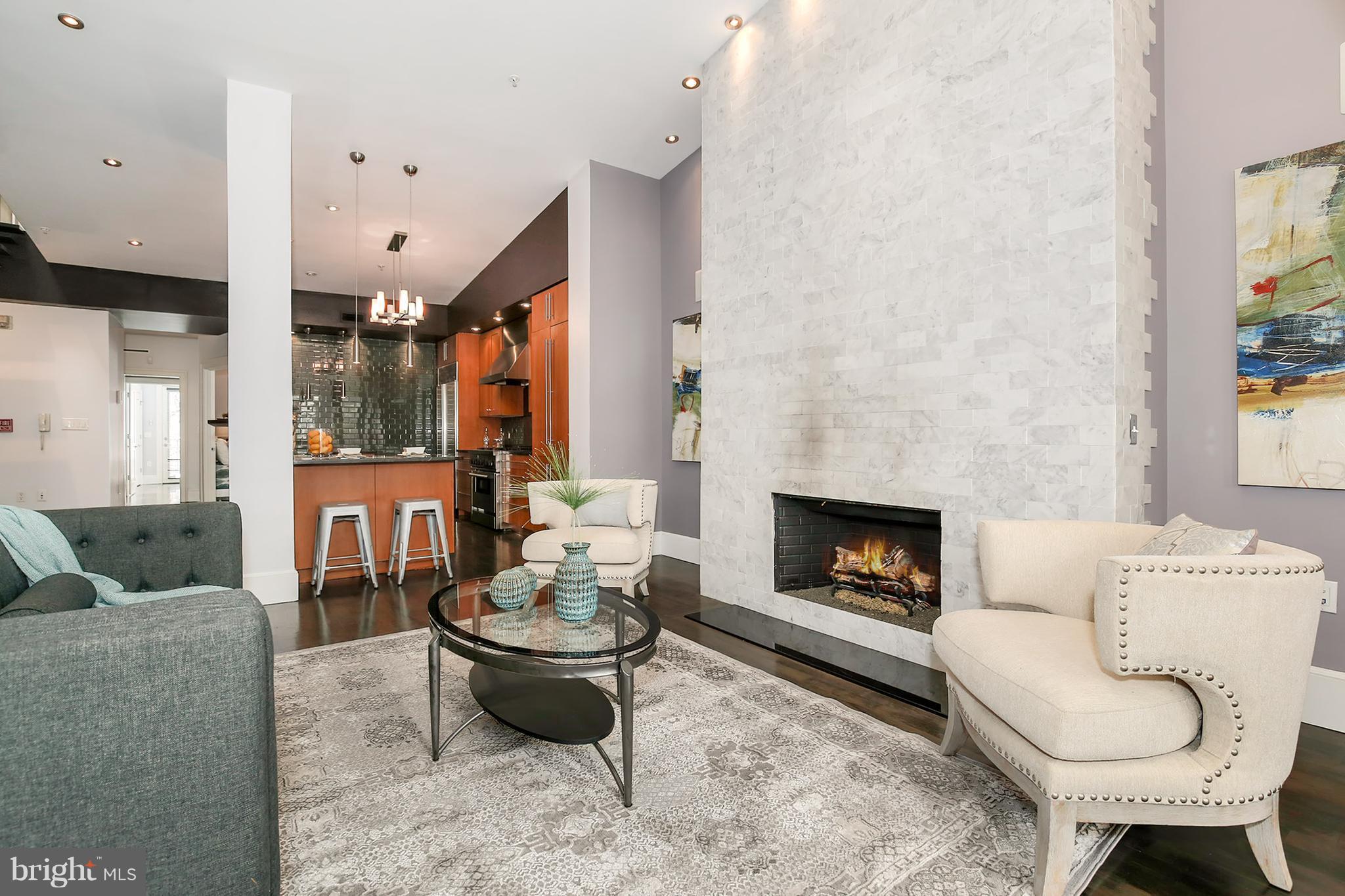 a living room with furniture and a fireplace