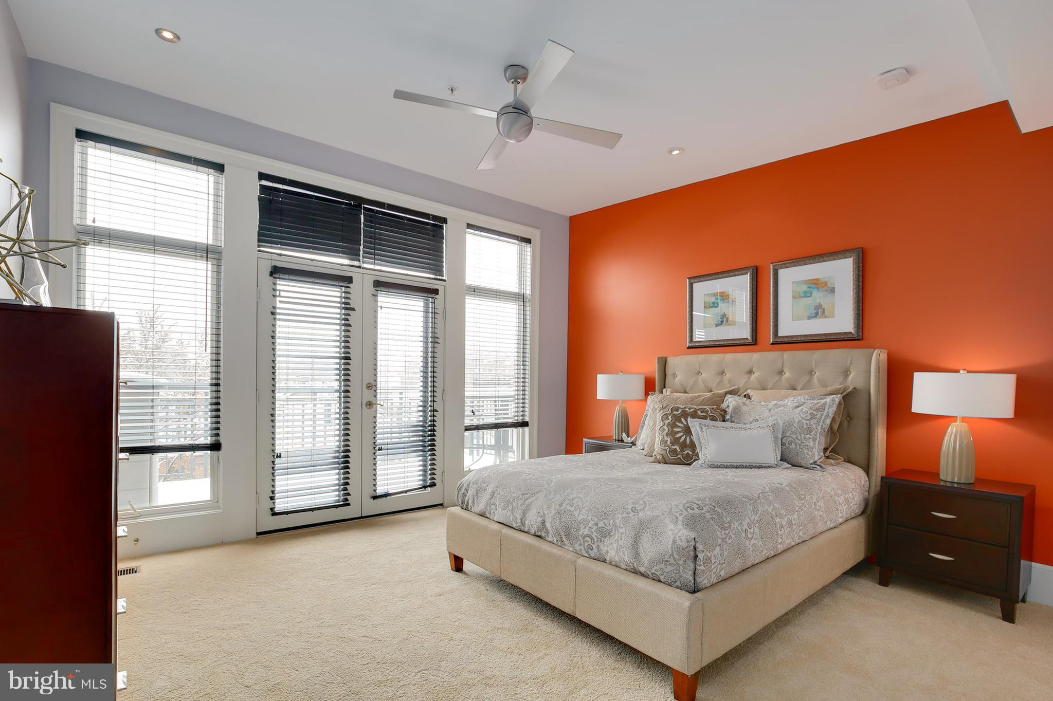 1433 R Street Northwest, Unit 4 Washington, DC 20009 - Photo 19 of 27 a spacious bedroom with a large bed and a chandelier